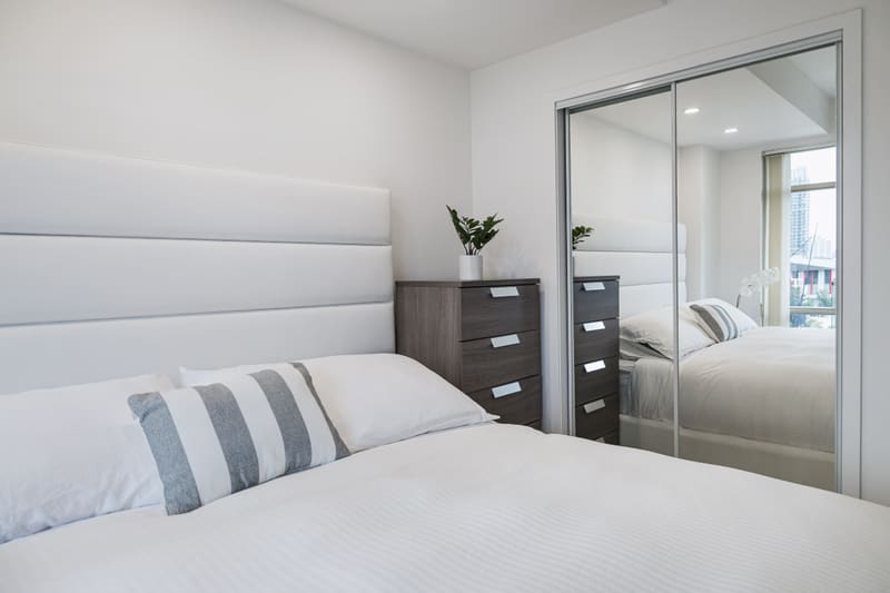 Maple Zen king bed with its channel headboard and the mirrored closet
